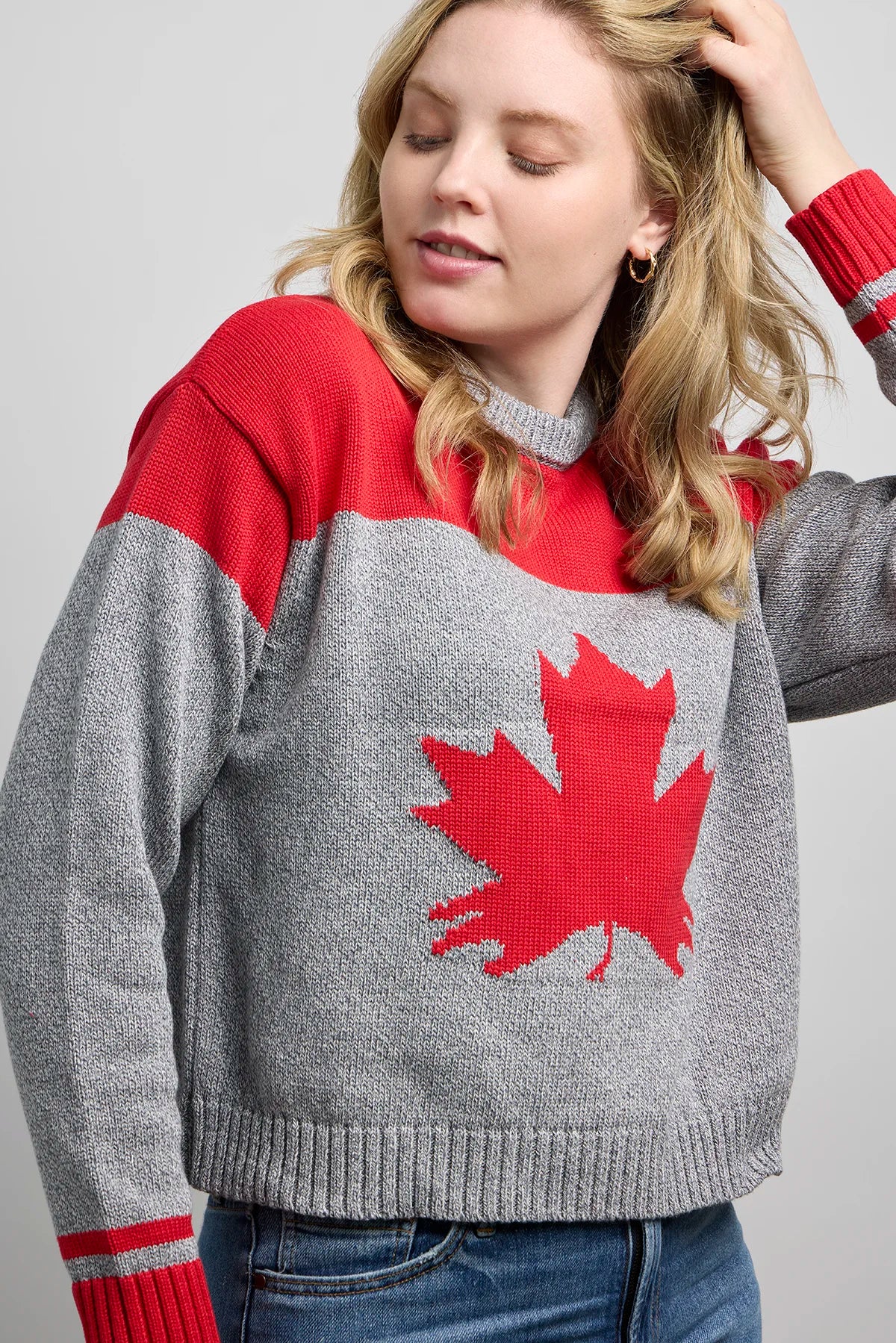Grey Canadian shorty sweater with red accents and a large red maple leaf design on the front.