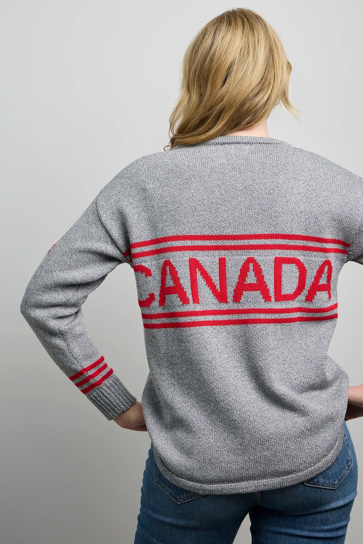 Grey maple leaf hockey sweater with CANADA lettering on the back