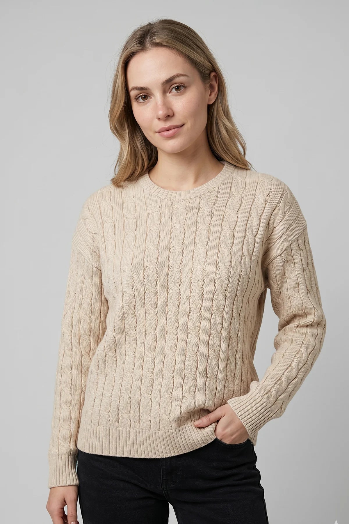 Cream cable knit sweater for women with classic textured knit pattern and ribbed cuffs, designed and made in Canada.