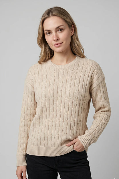 Cream cable knit sweater for women with classic textured knit pattern and ribbed cuffs, designed and made in Canada.