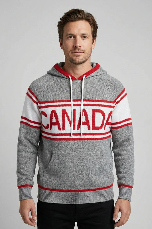 Man wearing a gray hoodie with 'Canada' printed on it against a plain background