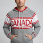 Man wearing a gray hoodie with 'Canada' printed on it against a plain background