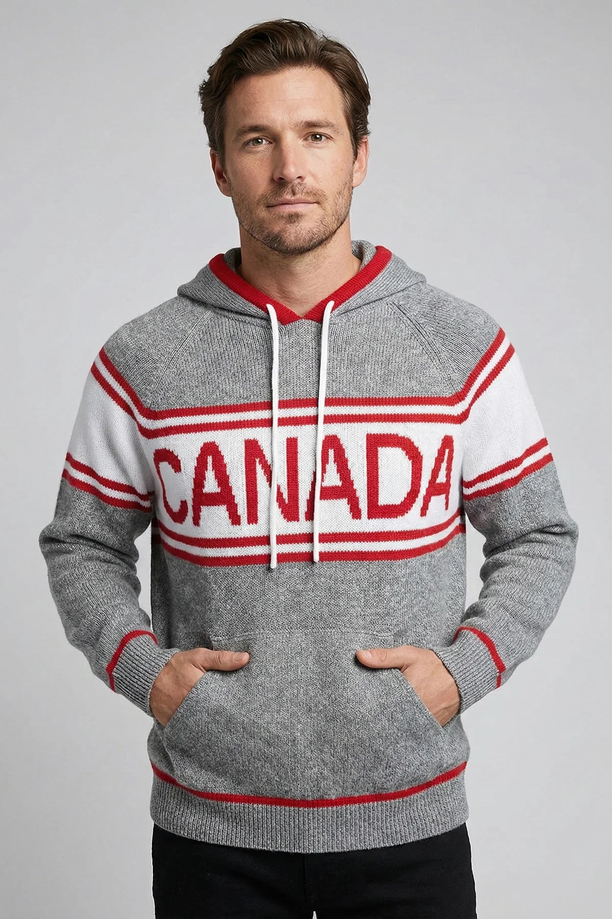 Man wearing a gray hoodie with 'Canada' printed on it against a plain background