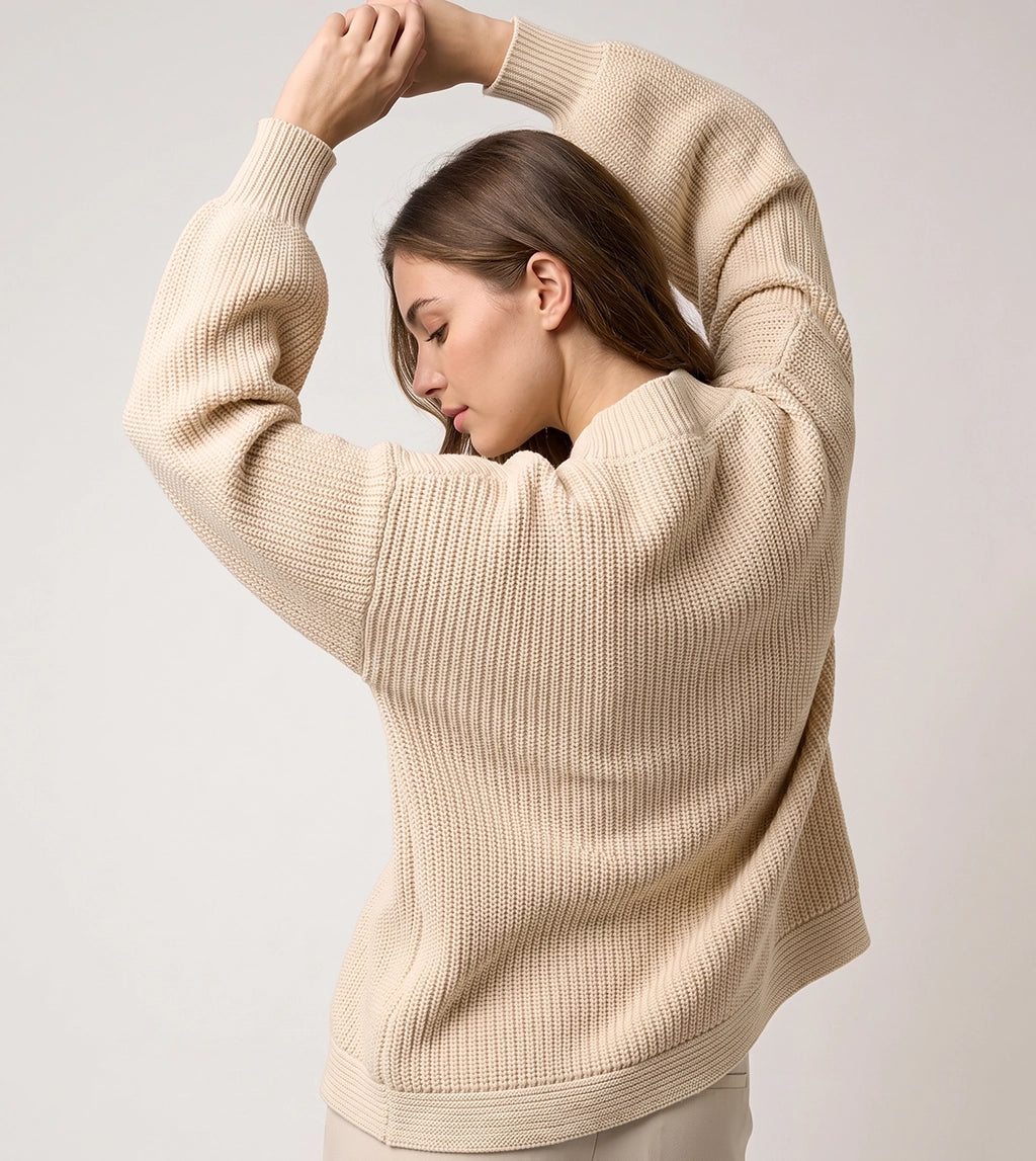 Back view of women’s cream chunky knit sweater with textured knit design.