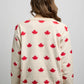 Back view of a knit sweater featuring an all-over maple leaf pattern with ribbed cuffs, hem, and crewneck.