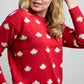 Side view of Falling Maples Sweater featuring an all-over maple leaf knit pattern with ribbed cuffs and hem.