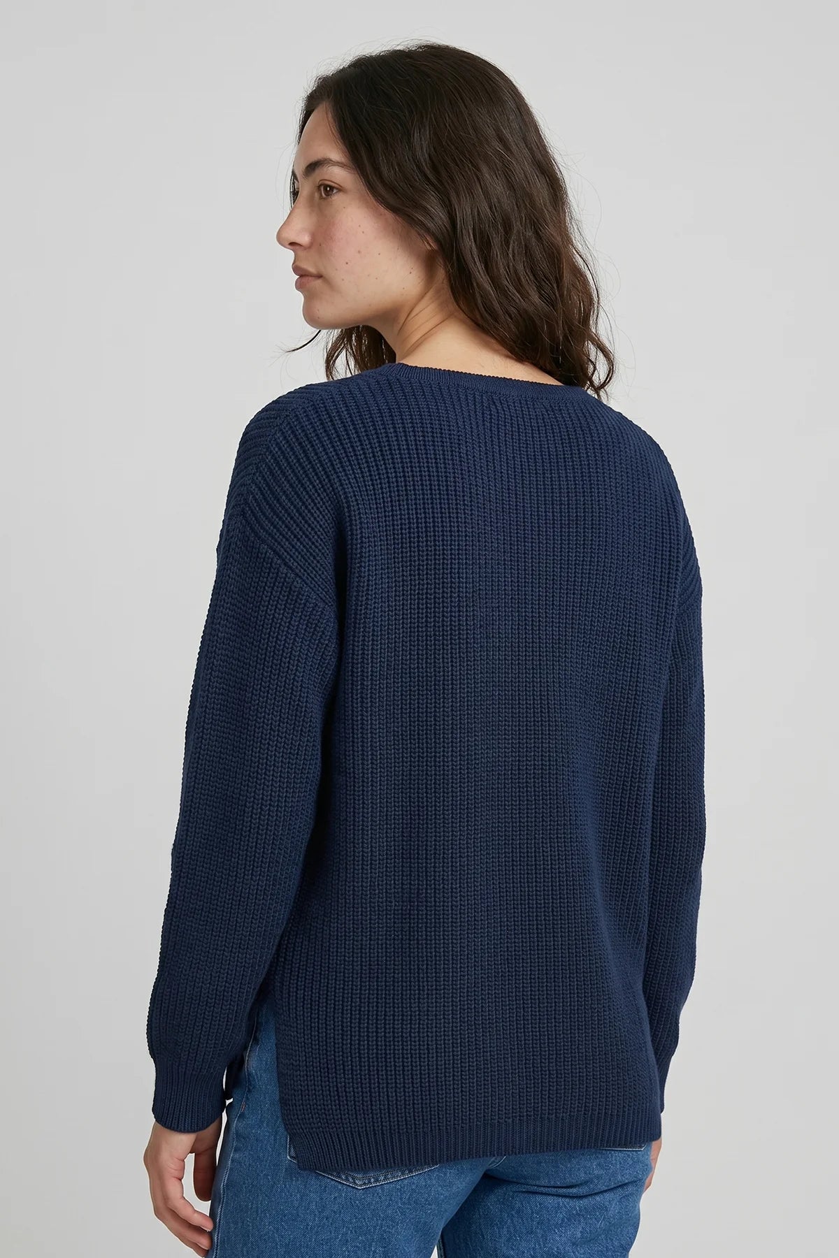 Back view of women’s navy fisherman sweater featuring textured knit construction and relaxed everyday fit.