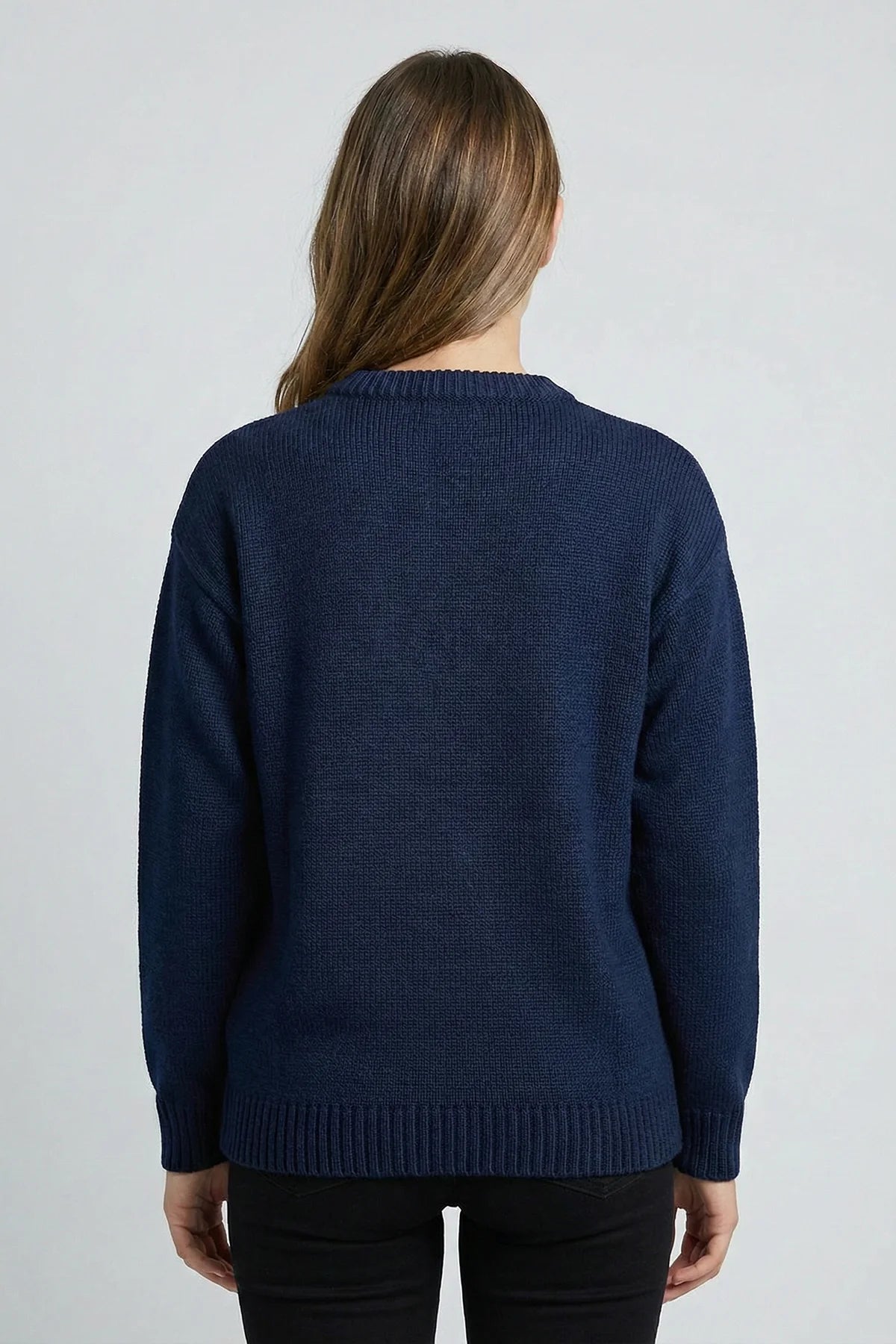 Person wearing a navy blue sweater on a light gray background