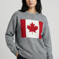 Person wearing a gray sweater with a Canadian flag design on a light gray background