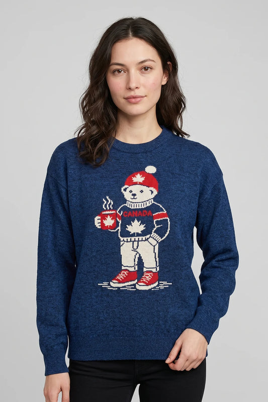 Woman wearing blue Maple Brew Sweater featuring a Canadian bear graphic holding a maple mug.