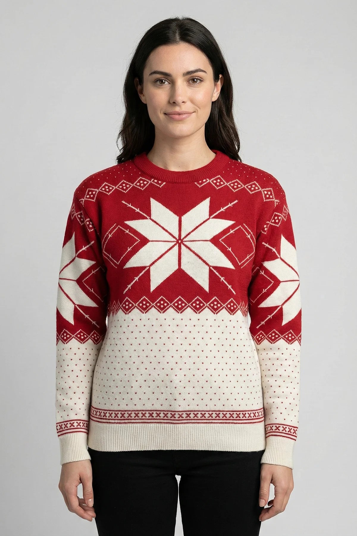 Woman wearing a red and white patterned sweater on a gray background