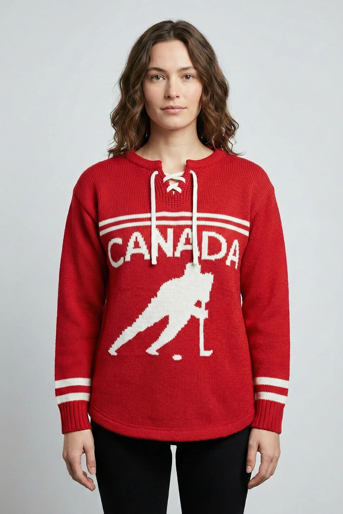 Person wearing a red sweater with 'Canada' and a hockey player silhouette on a gray background