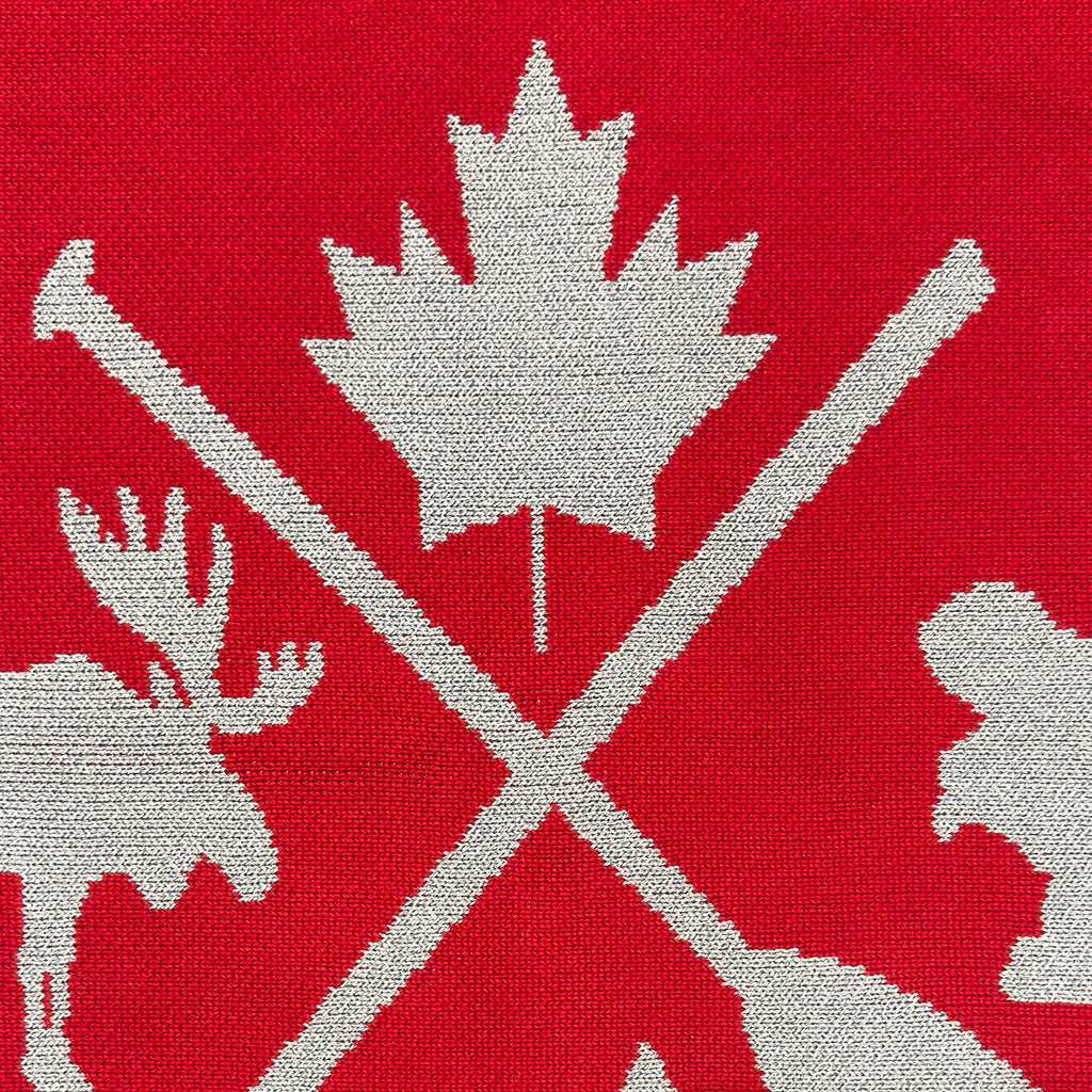 Textile pattern with a maple leaf and moose on a red background