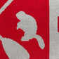 Close-up of a red and gray fabric pattern with abstract shapes