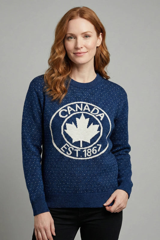 Woman wearing a blue sweater with a Canada maple leaf design on a gray background