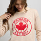 Front view of Sweater 1867 in knit fabric with dotted detailing, ribbed crewneck, and bold red maple leaf crest featuring Canada EST. 1867 text.