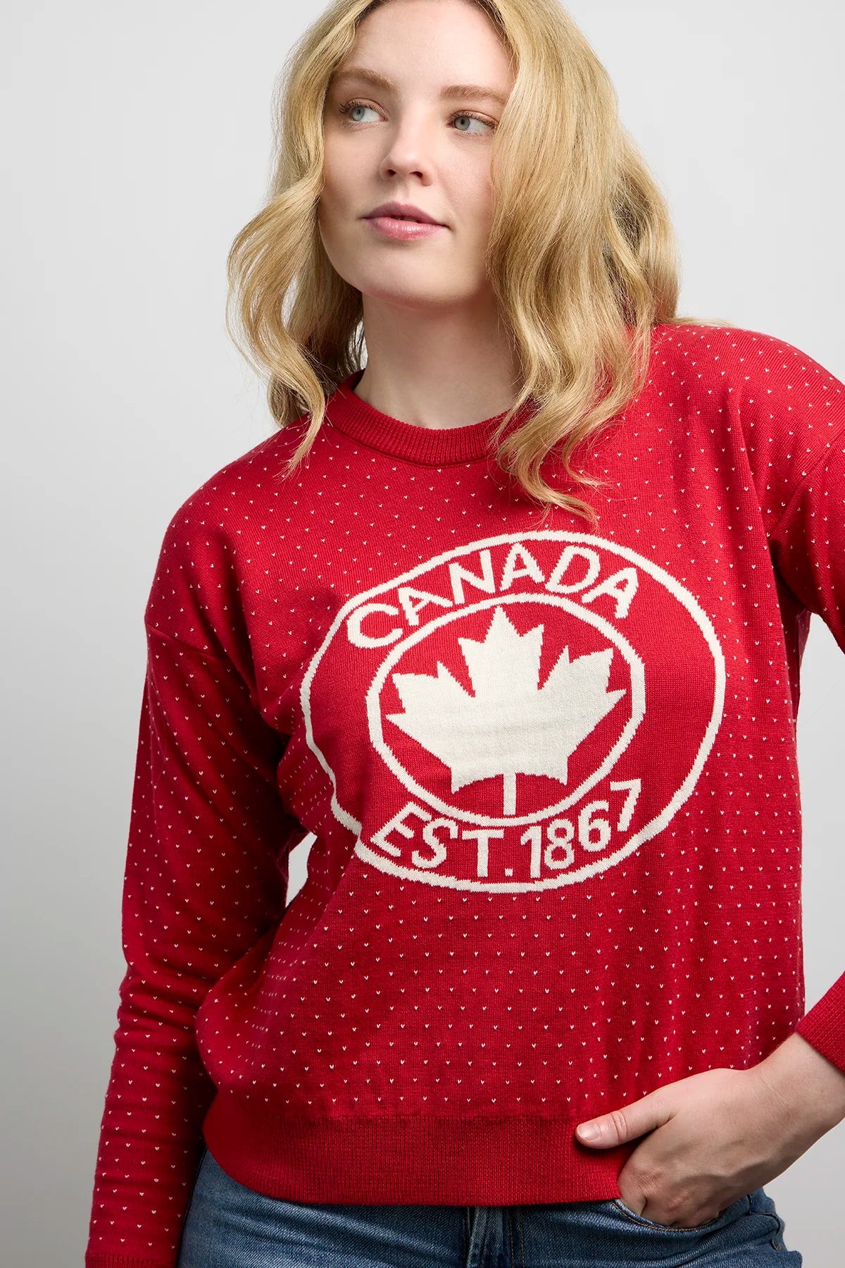Front view of Sweater 1867 featuring knit fabric with dotted detailing and bold maple leaf crest design with Canada EST. 1867 text.