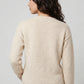 Back view of women’s cream waffle knit sweater featuring textured knit construction and ribbed hem detailing.